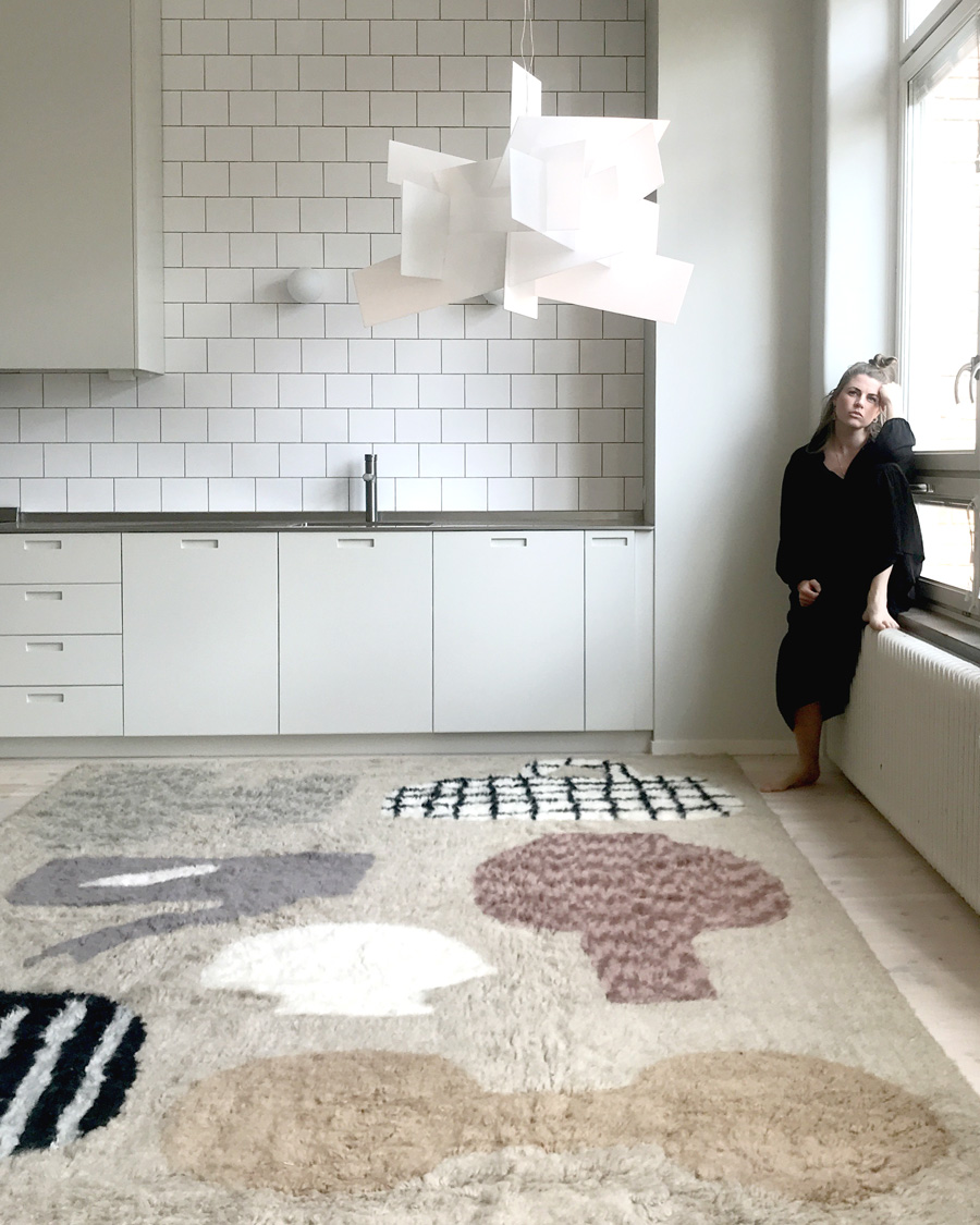 emilia ilke in her kitchen with patterned rug from layered